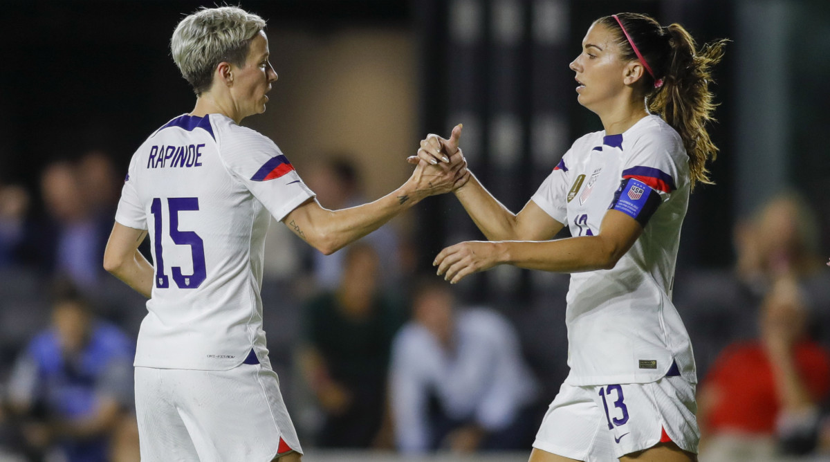 USWNT forward Megan Rapinoe celebrates with teammate Alex Morgan.